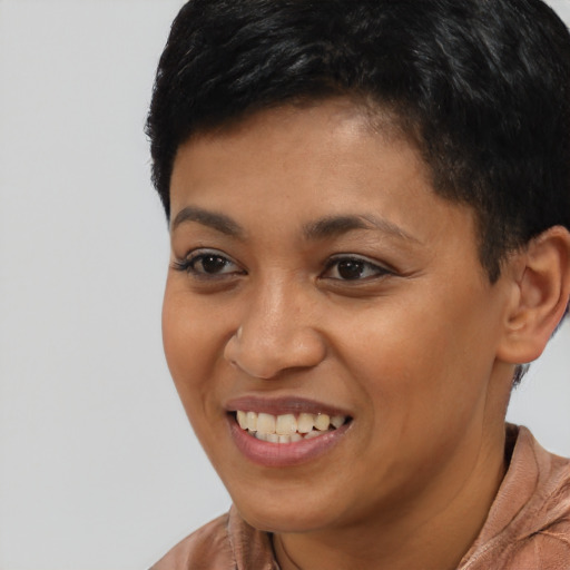 Joyful latino young-adult female with short  black hair and brown eyes