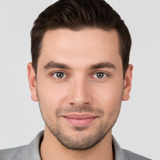 Joyful white young-adult male with short  brown hair and brown eyes