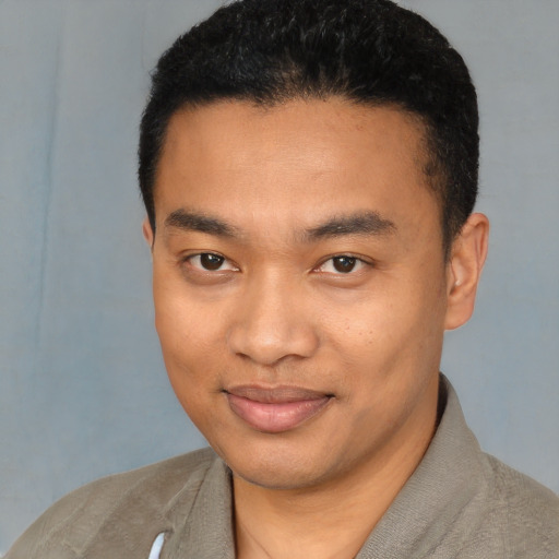 Joyful latino young-adult male with short  black hair and brown eyes