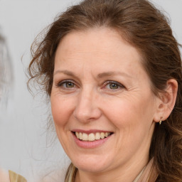 Joyful white adult female with long  brown hair and brown eyes