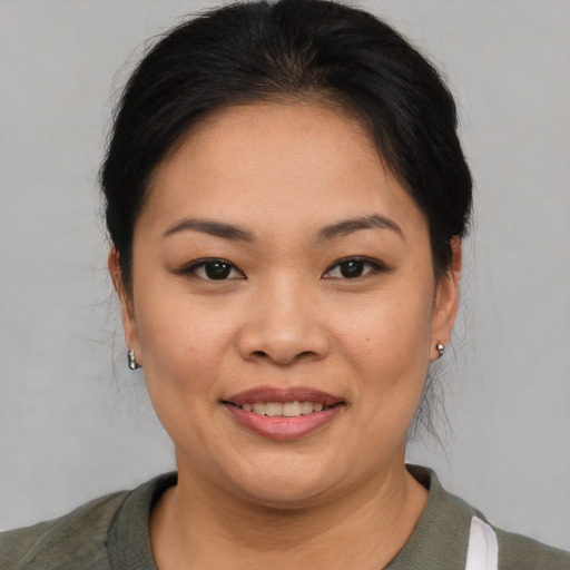 Joyful asian young-adult female with short  brown hair and brown eyes