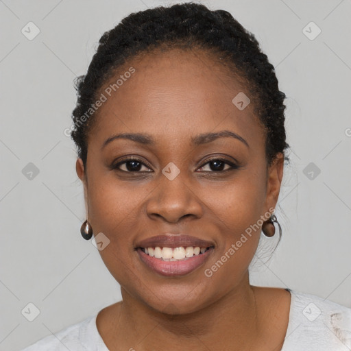 Joyful black young-adult female with short  brown hair and brown eyes