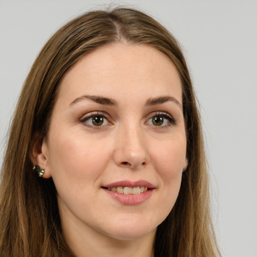 Joyful white young-adult female with long  brown hair and green eyes