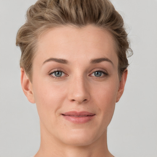 Joyful white young-adult female with short  brown hair and grey eyes