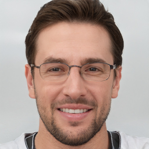 Joyful white adult male with short  brown hair and grey eyes