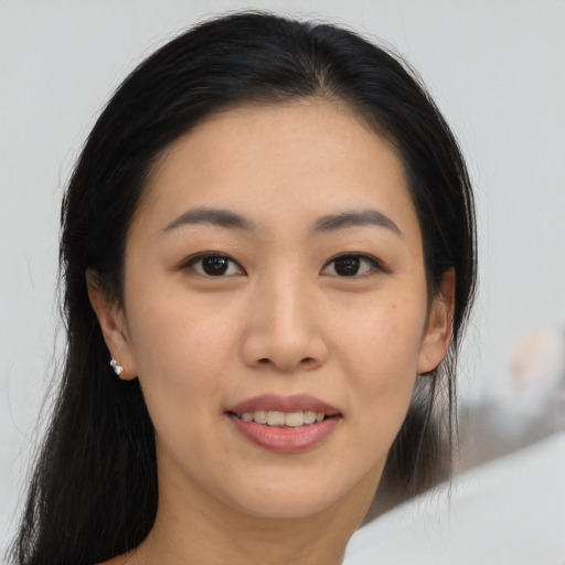 Joyful asian young-adult female with long  brown hair and brown eyes