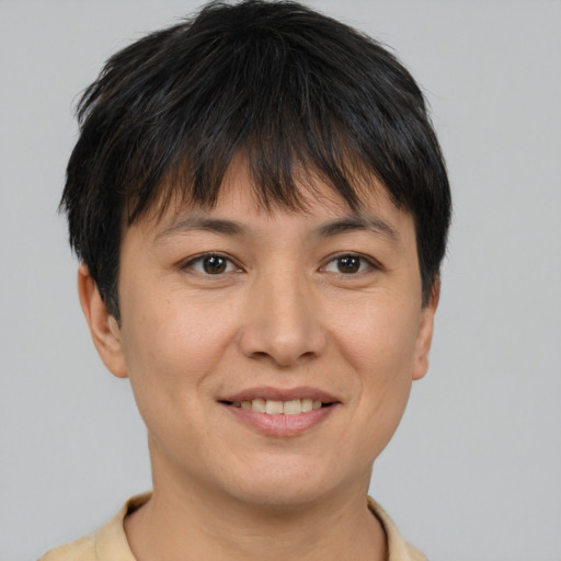 Joyful asian adult female with short  brown hair and brown eyes