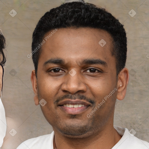 Joyful black young-adult male with short  black hair and brown eyes