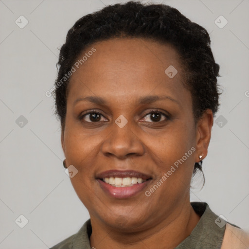 Joyful black adult female with short  brown hair and brown eyes