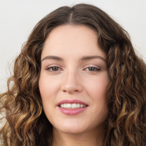 Joyful white young-adult female with long  brown hair and green eyes