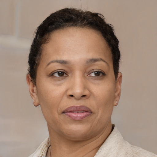 Joyful latino adult female with short  brown hair and brown eyes