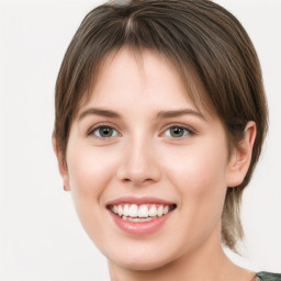 Joyful white young-adult female with medium  brown hair and green eyes