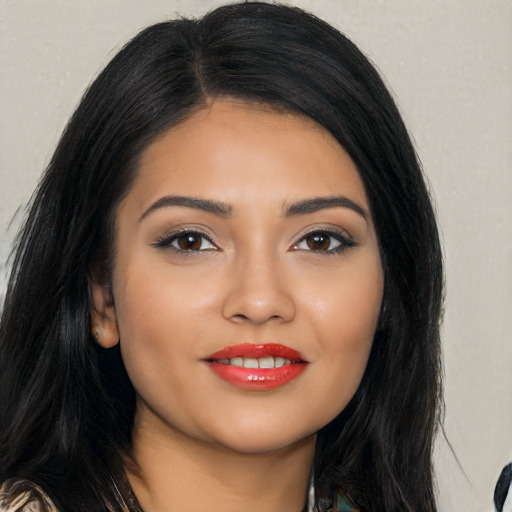 Joyful latino young-adult female with long  black hair and brown eyes