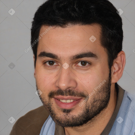 Joyful white young-adult male with short  black hair and brown eyes