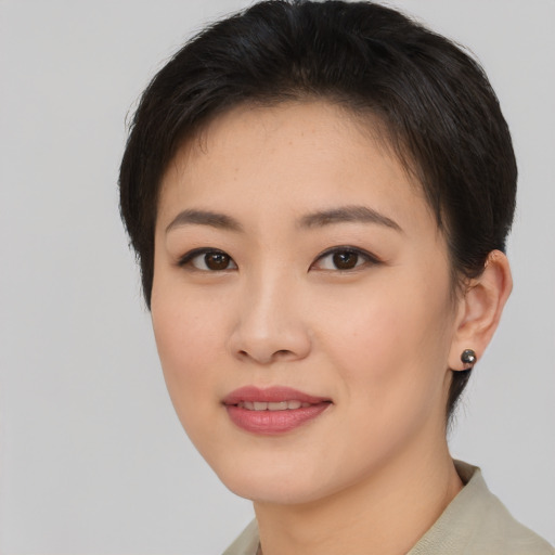 Joyful asian young-adult female with short  brown hair and brown eyes