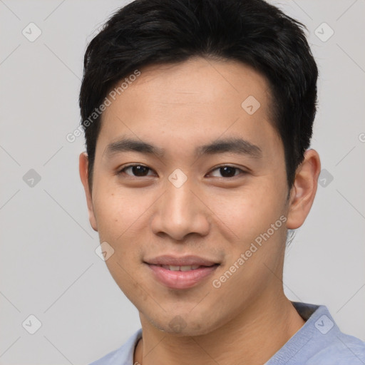 Joyful asian young-adult male with short  brown hair and brown eyes