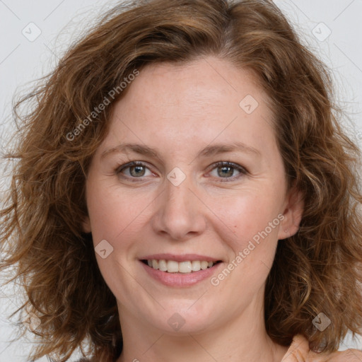 Joyful white young-adult female with long  brown hair and blue eyes