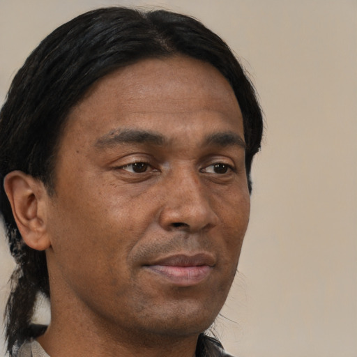 Joyful black young-adult male with short  brown hair and brown eyes