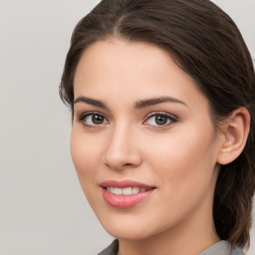 Joyful white young-adult female with long  brown hair and brown eyes