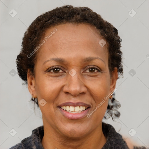 Joyful black adult female with short  brown hair and brown eyes