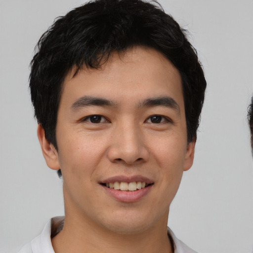 Joyful asian young-adult male with short  brown hair and brown eyes