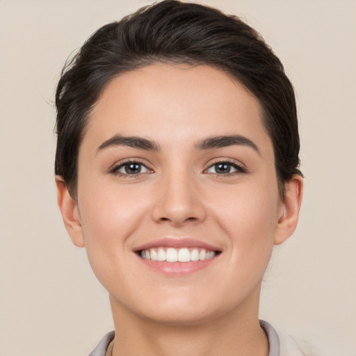 Joyful white young-adult female with short  brown hair and brown eyes