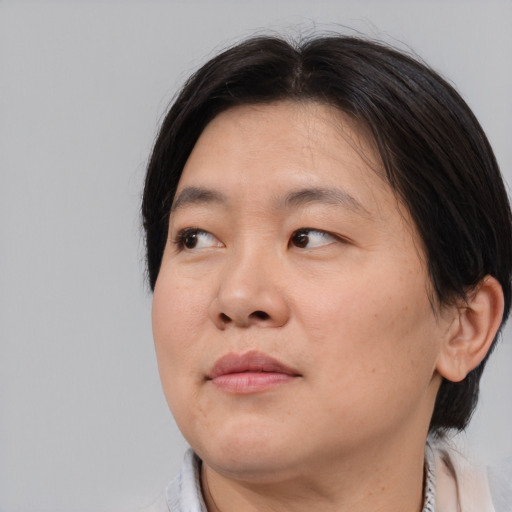 Neutral asian adult female with medium  brown hair and brown eyes