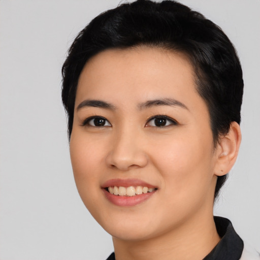 Joyful asian young-adult female with medium  black hair and brown eyes