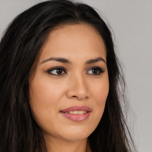 Joyful latino young-adult female with long  brown hair and brown eyes