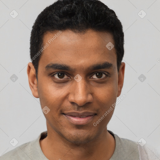 Joyful black young-adult male with short  black hair and brown eyes