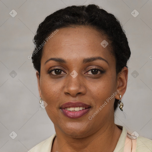 Joyful black adult female with short  brown hair and brown eyes