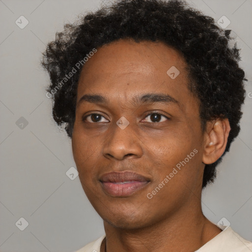 Joyful black adult male with short  black hair and brown eyes