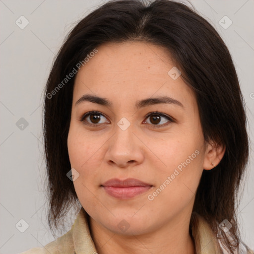 Joyful latino young-adult female with medium  brown hair and brown eyes