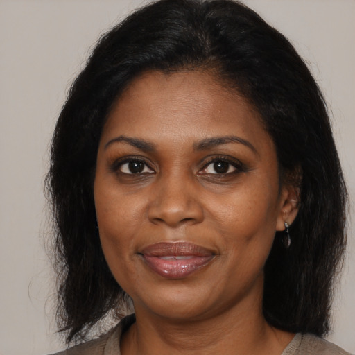Joyful black young-adult female with medium  brown hair and brown eyes