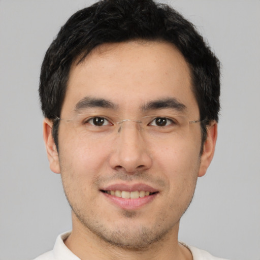 Joyful asian young-adult male with short  brown hair and brown eyes