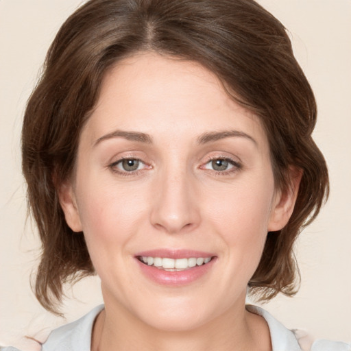 Joyful white young-adult female with medium  brown hair and green eyes