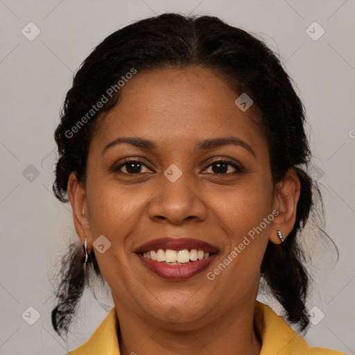 Joyful black adult female with medium  brown hair and brown eyes