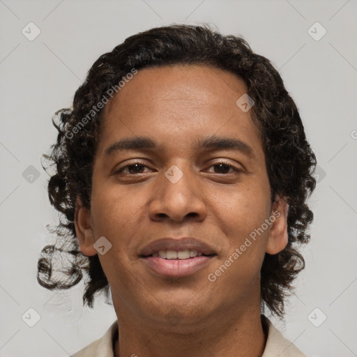 Joyful black young-adult male with short  brown hair and brown eyes