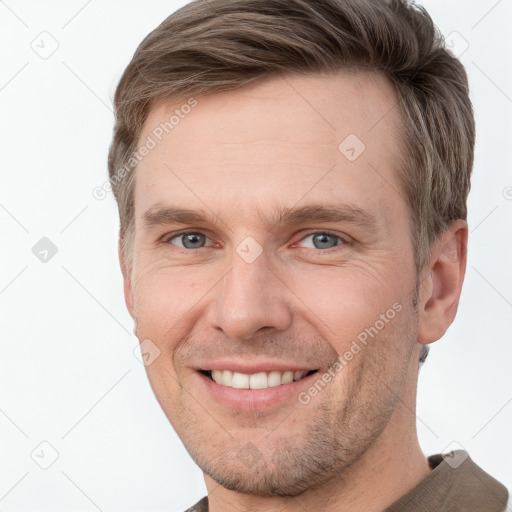 Joyful white adult male with short  brown hair and grey eyes