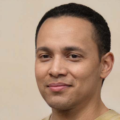 Joyful white young-adult male with short  black hair and brown eyes