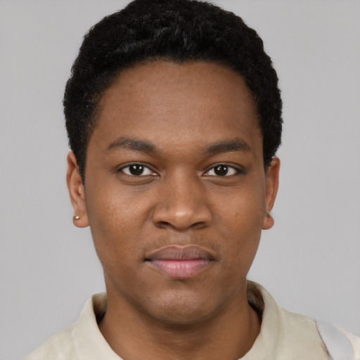 Joyful black young-adult male with short  black hair and brown eyes