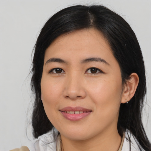 Joyful asian young-adult female with medium  black hair and brown eyes