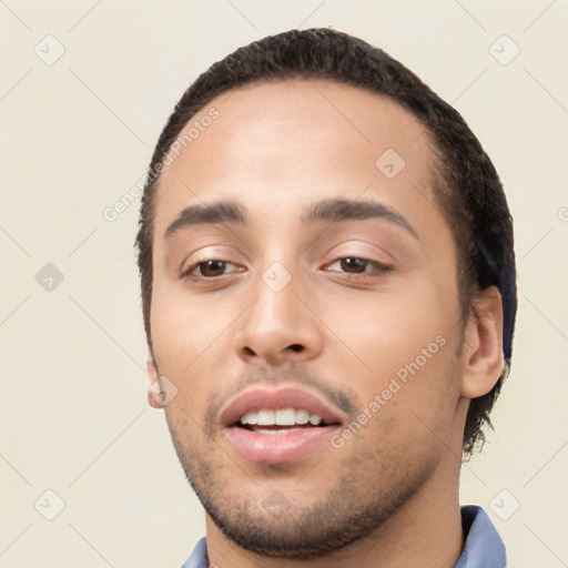 Joyful white young-adult male with short  black hair and brown eyes