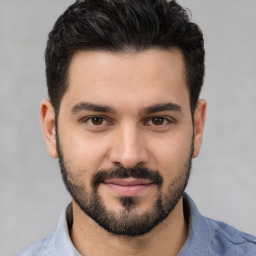 Joyful white young-adult male with short  black hair and brown eyes