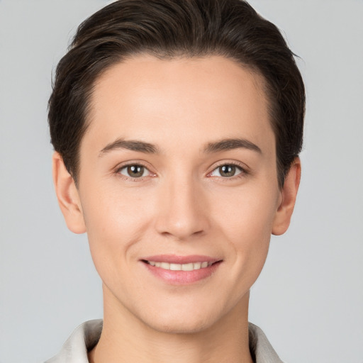 Joyful white young-adult female with short  brown hair and brown eyes