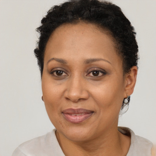Joyful latino adult female with short  brown hair and brown eyes