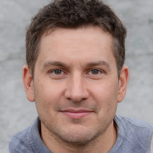 Joyful white adult male with short  brown hair and grey eyes