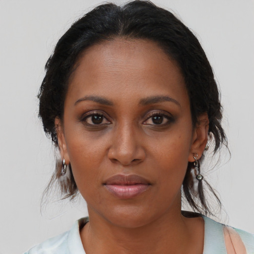 Neutral black young-adult female with medium  brown hair and brown eyes