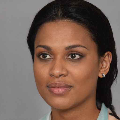 Joyful black young-adult female with long  black hair and brown eyes