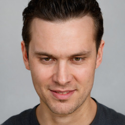 Joyful white adult male with short  brown hair and brown eyes